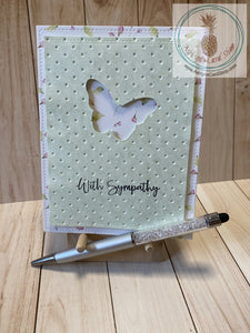 Butterfly Sympathy Card - A butterfly shape die cut out of a green patterned paper cardstock panel that has an embossed textured background and faux stitching detail.  The green panel is popped up on a patterned paper background that also has faux stitching detail.  External sentiment reads "with sympathy" and the internal sentiment reads "I am here for you always." Card size is 4.25 x 5.5" (A2). Coordinating envelope included (A2). Pink Floral option.