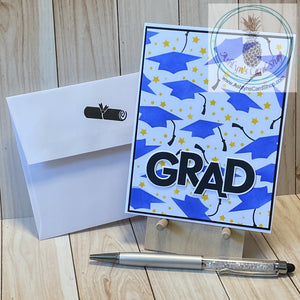 High quality handmade graduation card featuring flying grad caps in blue with black tassels and bright stars. Grad caps are stenciled on white, adhered to a black card panel and again to a white card base. External sentiment reads "grad" and the internal sentiment reads "the best is yet to come". A2 card size: 4.25 x 5.5". Coordinating envelope (shown) included.