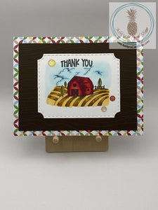 A thank you card with a farm theme. Hand coloured barn scene on brown cardstock and an additional layer of patterned card stock. A2 size card 4.25 x 5.5". Coordinating envelope included.