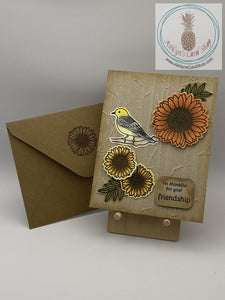 Bird and flowers on an embossed background friendship card. External sentiment reads I'm grateful for your friendship. Inside of the card is left blank for your personal message. A2 size card 4.25 x 5.5". Coordinating envelope (shown) included.