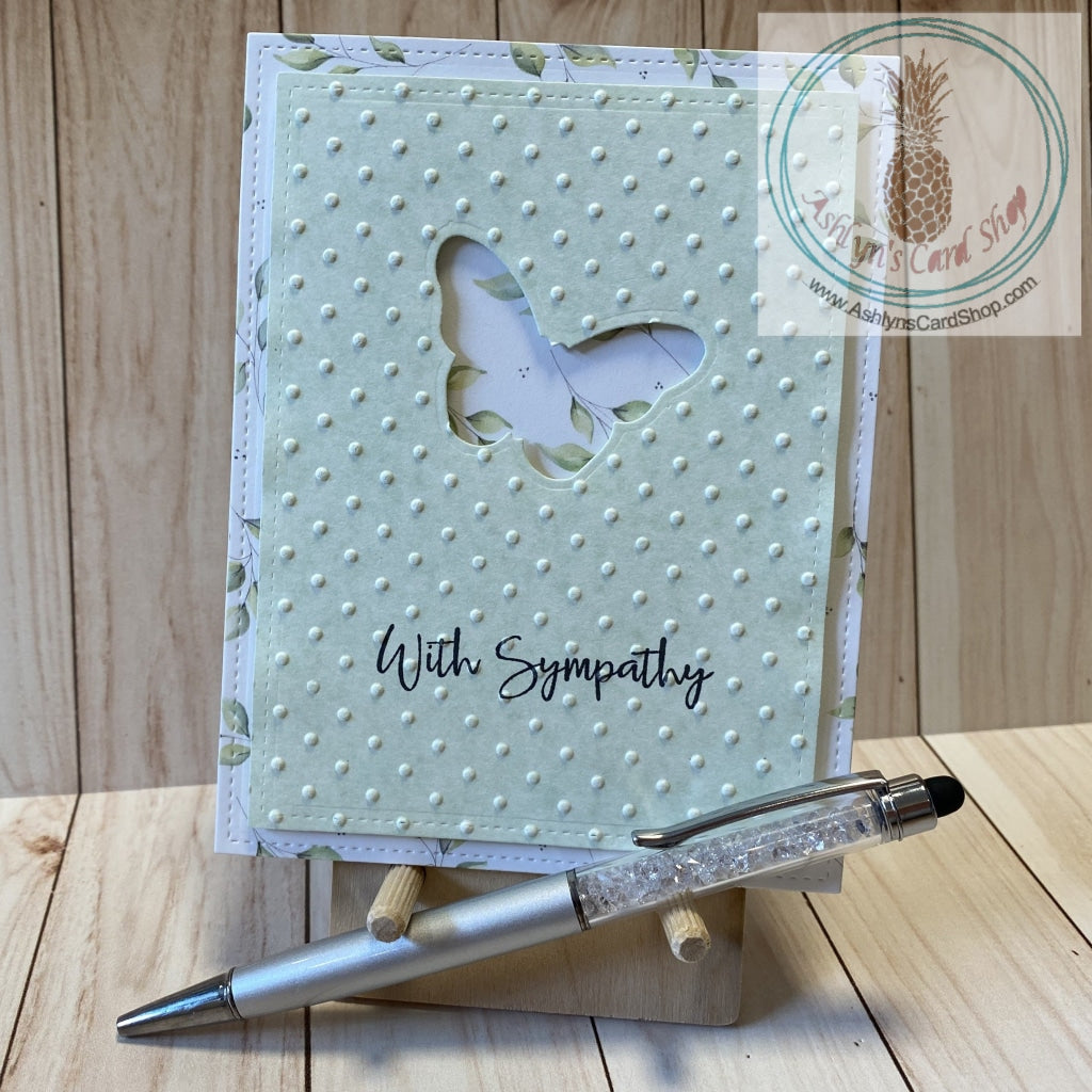 Butterfly Sympathy Card - A butterfly shape die cut out of a green patterned paper cardstock panel that has an embossed textured background and faux stitching detail.  The green panel is popped up on a patterned paper background that also has faux stitching detail.  External sentiment reads "with sympathy" and the internal sentiment reads "I am here for you always." Card size is 4.25 x 5.5" (A2). Coordinating envelope included (A2). Green leaf option.