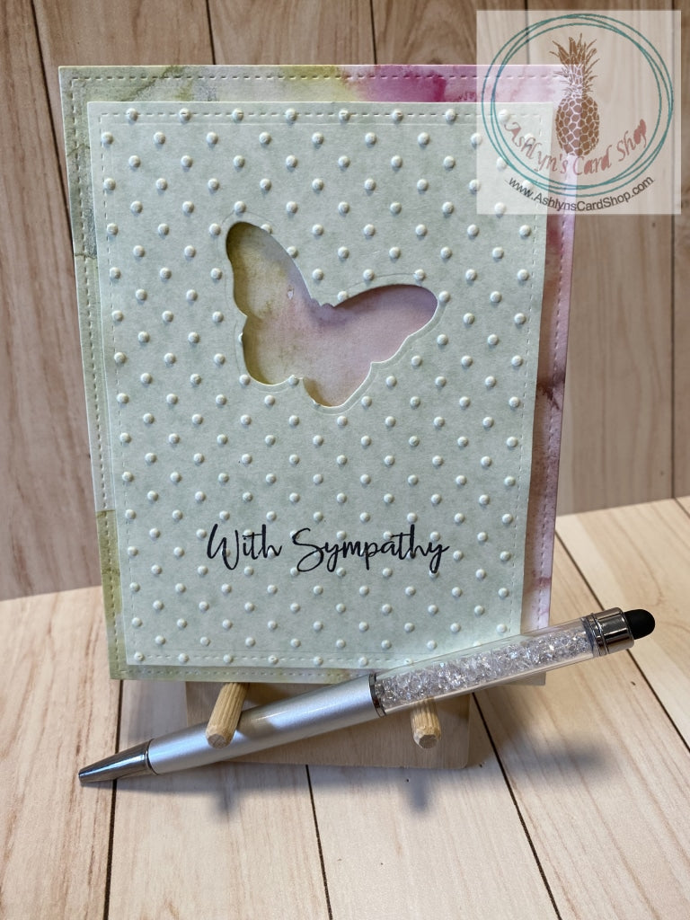 Butterfly Sympathy Card - A butterfly shape die cut out of a green patterned paper cardstock panel that has an embossed textured background and faux stitching detail.  The green panel is popped up on a patterned paper background that also has faux stitching detail.  External sentiment reads "with sympathy" and the internal sentiment reads "I am here for you always." Card size is 4.25 x 5.5" (A2). Coordinating envelope included (A2). Multicolour watercolour option.