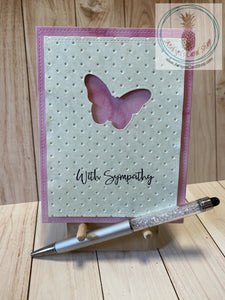 Butterfly Sympathy Card - A butterfly shape die cut out of a green patterned paper cardstock panel that has an embossed textured background and faux stitching detail.  The green panel is popped up on a patterned paper background that also has faux stitching detail.  External sentiment reads "with sympathy" and the internal sentiment reads "I am here for you always." Card size is 4.25 x 5.5" (A2). Coordinating envelope included (A2). Pink watercolour option.