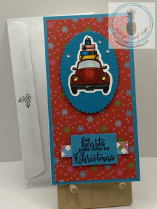 Car & Presents Christmas Card - A hand coloured Beetle-like car with wrapped Christmas presents piled on top. Available with a choice of two snowy backgrounds in either pink or red. External sentiment reads “All hearts come home for Christmas” and the internal sentiment reads “Be Merry”. Mini slim size: 3.25 x 6.25”. Coordinating envelope included (shown).
