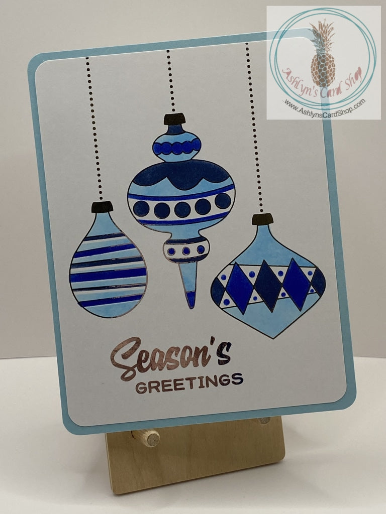 Christmas Baubles Card - Blue version: ink blended Christmas ornaments with foil accents in silver. External sentiment reads: "Season's Greetings" and "The true joy of the season is in the love shared with family and friends." A2 size card: 4.25 x 5.5”. Coordinating envelope included.