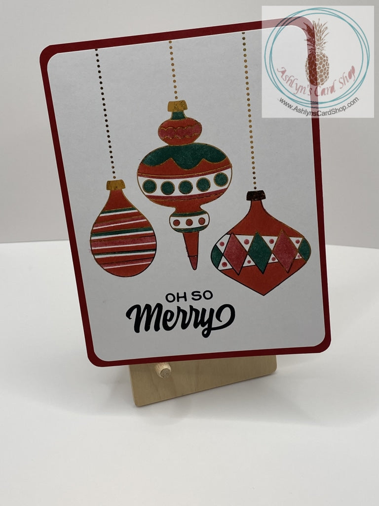 Christmas Baubles Card - Red version: ink blended Christmas ornaments with foil accents in gold. External sentiment reads: "Oh so Merry" and the internal sentiment reads "The most heartfelt of Christmas wishes to you and your family." A2 size card: 4.25 x 5.5”. Coordinating envelope included. 