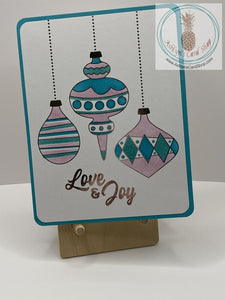 Christmas Baubles Card - Teal version: ink blended Christmas ornaments with foil accents in silver. External sentiment reads: "Love & Joy" and "The true joy of the season is in the love shared with family and friends." A2 size card: 4.25 x 5.5”. Coordinating envelope included.