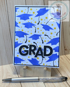 High quality handmade graduation card featuring flying grad caps in blue with black tassels and bright stars. Grad caps are stenciled on white, adhered to a black card panel and again to a white card base. External sentiment reads "grad" and the internal sentiment reads "the best is yet to come". A2 card size: 4.25 x 5.5". Coordinating envelope included.