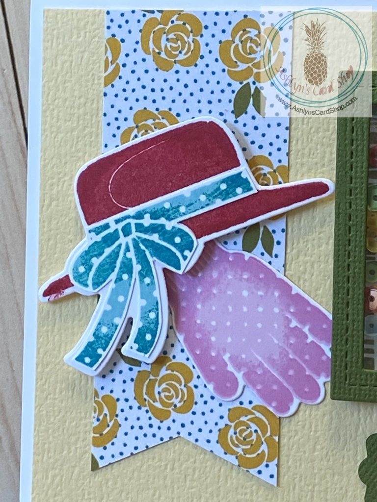 Close up of the banner detail, sun hat and gardening glove featured on the front of the Gardener's Birthday Card (Shaker) available at Ashlyn's Card Shop.