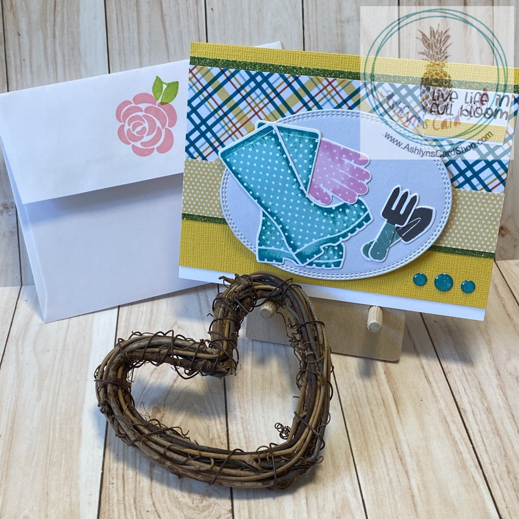 Gardening themed notecard - teal and pink gardening tools on a bright and cheerful yellow, teal and white card front. Coordinating envelope shown.