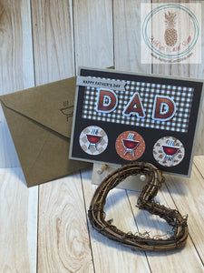 Father's Day card with a barbeque theme. High quality handmade greeting card with hand coloured images that represent Dads. Mounted to a kraft coloured card base, a dark brown die cut frame with inlaid pieces of patterned paper showcases the sentiments and coloured images in this design. Patterned paper varies amongst the versions. A2 Card Size: 4.25 x 5.5". Coordinating envelope (shown) included. Grill version.