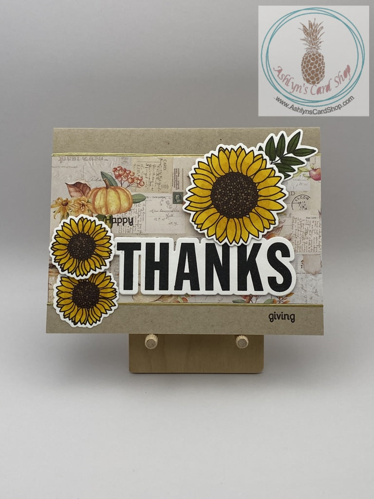 Thanksgiving card with sunflowers as accents. Hand coloured flowers on a patterned paper background. Two backgrounds available: patterned paper shown. A2 size card: 4.25 x 5.5". Coordinating envelope included.