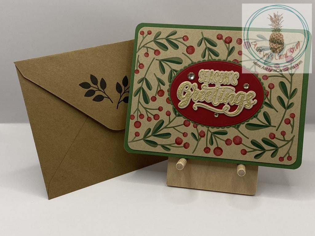 Holly Sprig Christmas Cards - Season's Greetings. Internal sentiment reads "May the peace and joy of the season be with you throughout the new year." Coordinating envelope shown.