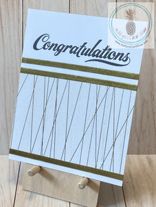 High quality handmade wedding cards featuring simple gold and white designs with  sentiments stamped in black. Decorative tape and foil tape in gold mounted on a white card base.  Sentiments read "Congratulations on your wedding". A2 card size: 4.25 x 5.5".  Coordinating envelope included. Triple stripe version.