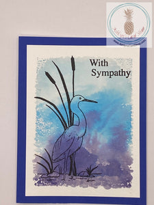 Sympathy card with a watercolour wash background stamped with a crane (on blue) in silhouette. The sentiments read: with sympathy (external) and thinking of you at this very sad time (internal). A2 sized card: 4.25 x 5.5". Coordinating envelope included.