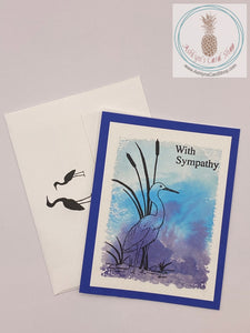 Sympathy card with a watercolour wash background stamped with a crane (on blue) in silhouette. The sentiments read: with sympathy (external) and thinking of you at this very sad time (internal). A2 sized card: 4.25 x 5.5". Coordinating envelope included (shown).