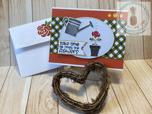 For the indoor gardener in your life. Watering a potted plant scene on an orange, green and white background. External sentiment reads "take time to smell the flowers" and the inside is blank for your personal message. A2 card size (4.25 x 5.5"). Coordinating envelope (shown) included.