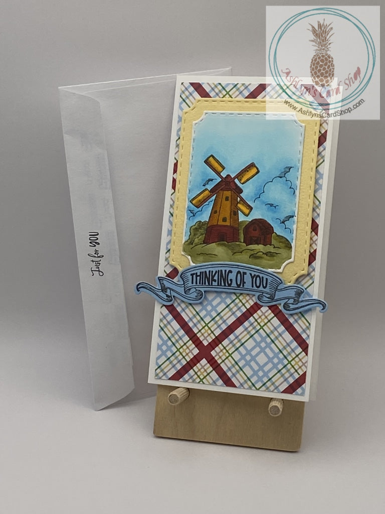 Hand coloured windmill scene on a plaid background. Two sentiment choices: thinking of you/be classy, sassy and a bit smart assy!  And, hello friend/dip in in chocolate. It'll be fine. Mini slimline card 3.5 x 6.5". Coordinating envelope included. (shown)