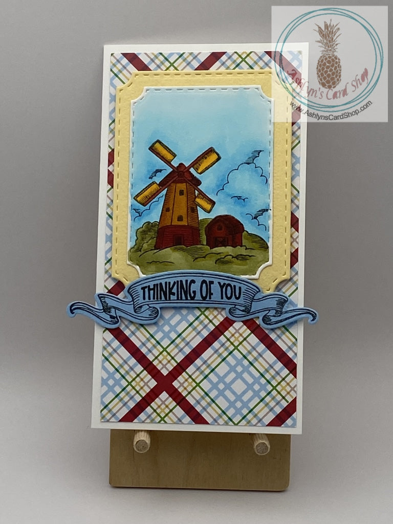 Hand coloured windmill scene on a plaid background. Two sentiment choices: thinking of you (shown)/be classy, sassy and a bit smart assy!  And, hello friend/dip in in chocolate. It'll be fine. Mini slimline card 3.5 x 6.5". Coordinating envelope included.