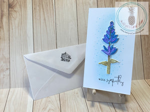 With Sympathy Watercolour Floral Card - Watercoloured wildflower on a white card front with a blended blue halo and stamped blue speckles. The external sentiment reads "with sympathy" and the internal sentiment reads "thinking of you". Blue/purple colour option. Card size is 3.5 x 6" (mini slim). Coordinating No. 8 envelope included (shown).